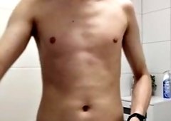 A young man takes a shower and masturbates shaved, cut his penis