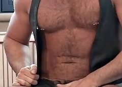 Solo leather bear jerking off a hard cock until he cums