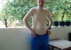 Kudoslong on the balcony undresses naked, he shows his semi-erect shaved cock and jerks off until he is erect and gets dressed